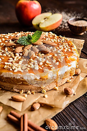 Apple cake with whipped cream, caramel and almond topping Stock Photo