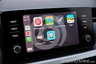 Apple CarPlay screen in the car dashboard. Youtube music, Waze, 2GIS, Here WeGo, Sygic, TomTom Go logo on the screen in Editorial Stock Photo
