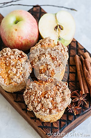 Apple cinnamon crumble muffins on a wooden board. White stone ba Stock Photo