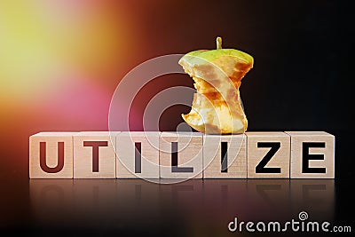 An apple core and the word UTILIZE are written on the cubes. Ecology and waste recycling concept Stock Photo