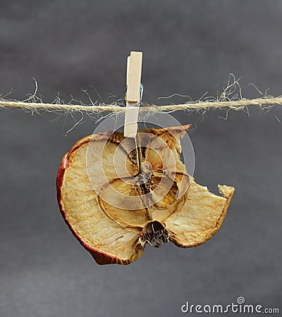 Apple dried bitten with a clothespeg Stock Photo