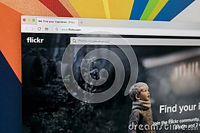 Apple iMac with Flickr homepage on monitor screen. Flickr is the video hosting network website. Homepage of Flickr.com on PC Editorial Stock Photo