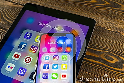 Apple iPad and iPhone X with icons of social media facebook, instagram, twitter, snapchat application on screen. Social media icon Editorial Stock Photo