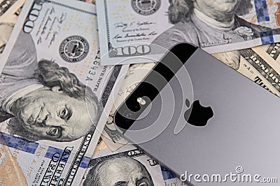 Selinsgrove, PA, USA - March 31, 2019 : An Apple iPhone sits on top of a pile of United States currency. Editorial Stock Photo