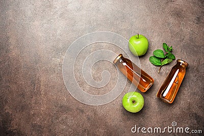 Apple juice in a bottle, green apple and fresh mint leaves on a dark rustic background. Top view, flat lay, copy space Stock Photo