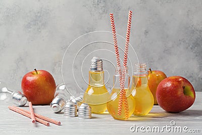 Apple juice in cute light bulb jars Stock Photo