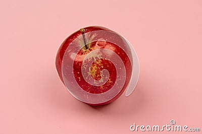 Apple on a light background in the center with space Stock Photo