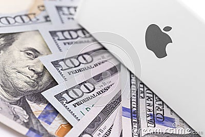 Apple logo on the box, dollars. Apple is a multinational technology company that designs, develops, and sells Editorial Stock Photo