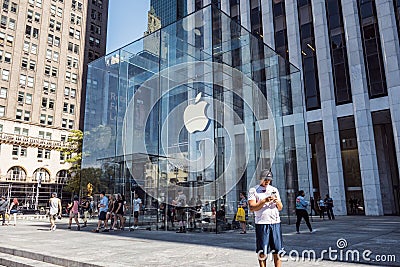 Apple Logo hung in the glass cube entrance to the famous Fifth Avenue Apple Store in New York. Editorial Stock Photo