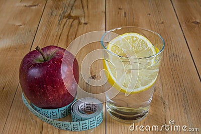 Apple with measuring tape and water drink with lemon Stock Photo