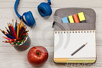 Apple, metal stand for pencils with color pencils, headphones, o Stock Photo