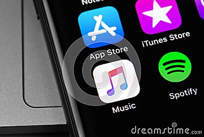 Apple Music and Spotify icon apps on the screen Editorial Stock Photo
