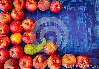 Apple with peach, nectarine, and pear on blue background, raw healhy food concept Stock Photo