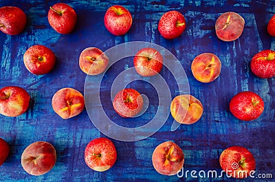 Apple with peach in rows on blue background, raw healhy food concept Stock Photo