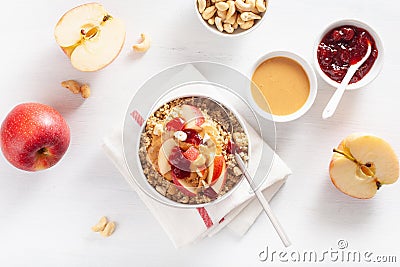 Apple peanut butter quinoa bowl with jam and cashew for healthy breakfast Stock Photo