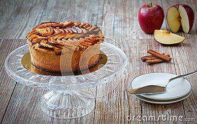 Apple pie on crystal cake plate on wooden table Stock Photo