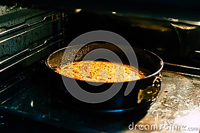 We bring an apple pie in a black oven Stock Photo