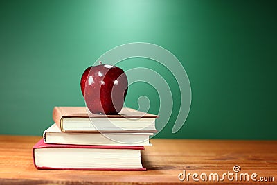 Apple Plus Stack of Books on A Desk for Back to School Stock Photo