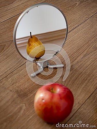Apple reflection in mirror as pear Stock Photo