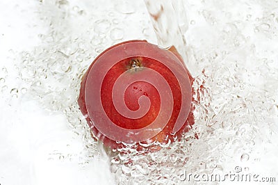 Apple splashing in cool water. Stock Photo