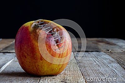 Apple with stapler Stock Photo