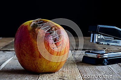 Apple with stapler Stock Photo