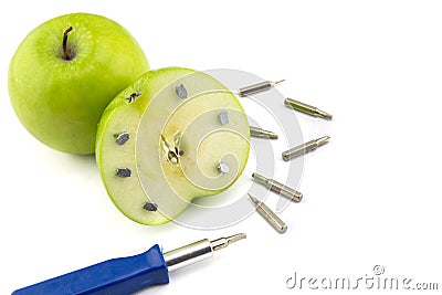 Apple stuck with nails, detail of a fruit with iron, tool Stock Photo