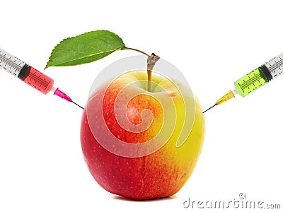 Apple stuck with syringe, Concept of genetic modification of fruits Stock Photo