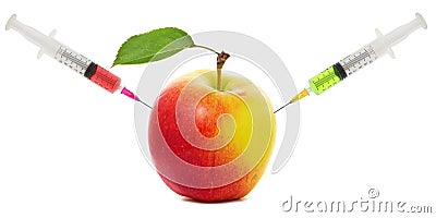 Apple stuck with syringe, Concept of genetic modification of fruits Stock Photo
