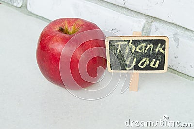 Apple with a Thank you inscription on a wooden Board black background Stock Photo