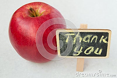 Apple with a Thank you inscription on a wooden Board black background Stock Photo