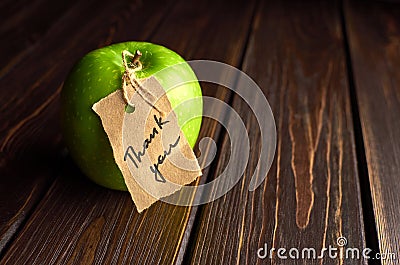 Apple with thank you lable on dark wooden background. Happy thanksgiving day concept Stock Photo