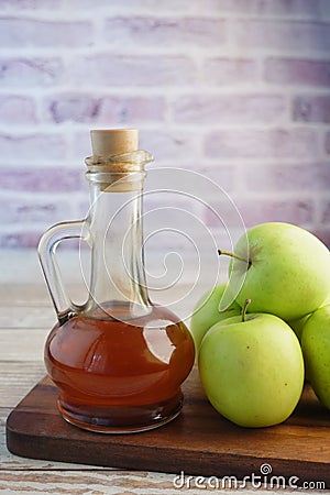 apple vinegar in glass bottle with fresh green apple on table Stock Photo