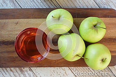 apple vinegar in glass bottle with fresh green apple on table Stock Photo