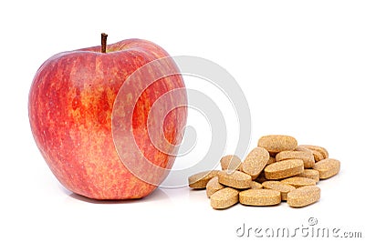 Apple and vitamins in tablets. Stock Photo