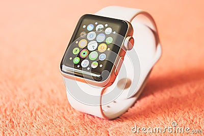 Apple Watch Gold on a soft fluffy peach-colored background Editorial Stock Photo
