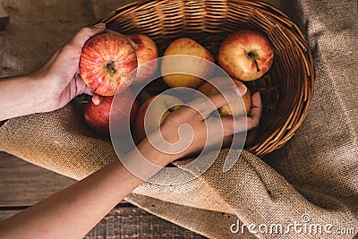 Apples in a basket taken by a woman Stock Photo