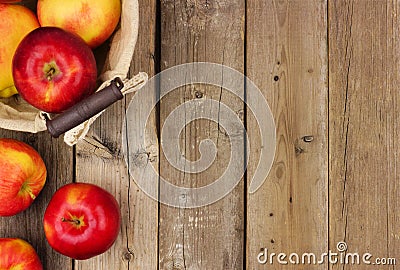 Apples with basket, side border on rustic aged wood Stock Photo