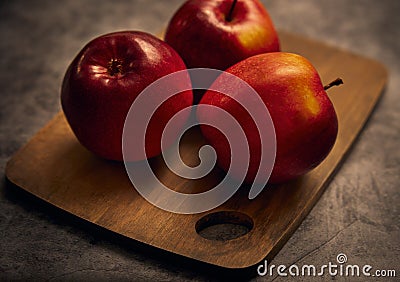 Apples board. Apples are on a cutting board with a dark background Stock Photo