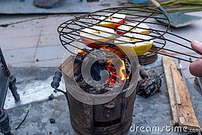 Apples cooking on a on an old, vintage wood stove, in flames Stock Photo