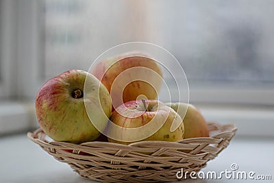 Apples lie in a wicker basket close-up Stock Photo