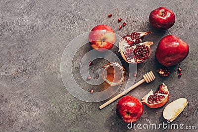 Apples, pomegranate and honey on a dark rustic background. New Year - Rosh Hashana. Traditional Jewish food. Top view, copy space Stock Photo