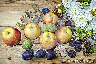 Apples,prunes,figs and green nuts with a bouquet of white dahlias Stock Photo