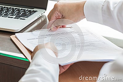 Applicant filing in company application form document applying for job, or registering claim for health insurance Stock Photo