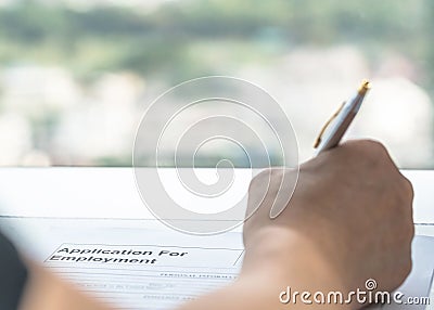 Applicant filling in company application form document applying for job, or registering claim for health insurance Stock Photo