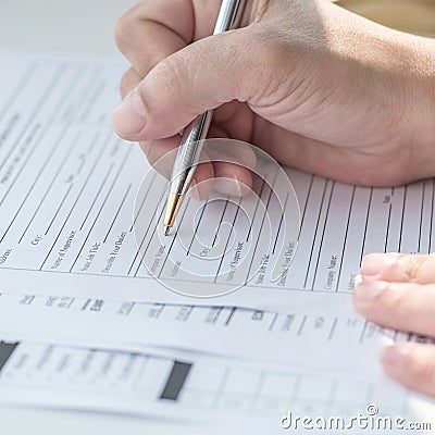 Applicant filling in company application form document applying for job, or registering claim for health insurance Stock Photo