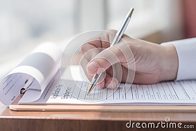 Applicant filling in company application form HR human resource document applying for job, or registering claim for insurance Stock Photo