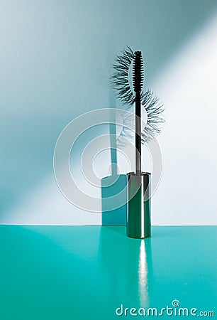 Applicator mascara and false eyelashes with drop shadow on sea-green background Stock Photo