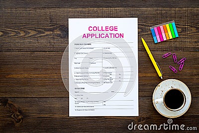 Apply college. Empty college application form near coffee cup and stationery on dark wooden background top view copy Stock Photo
