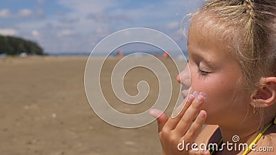 Apply sunscreen to face and body. Stock Photo
